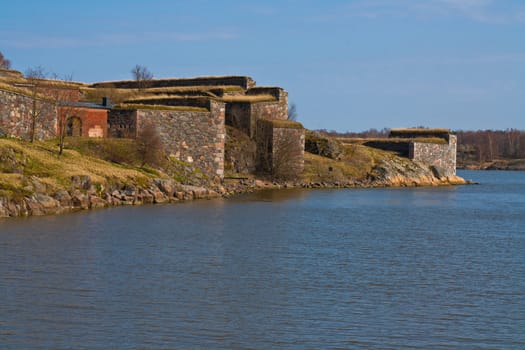 castle ruins wall and a water leading to ocean