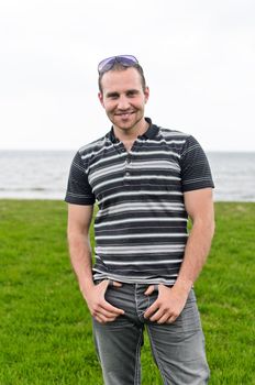 Handsome smiling man near the seaside.