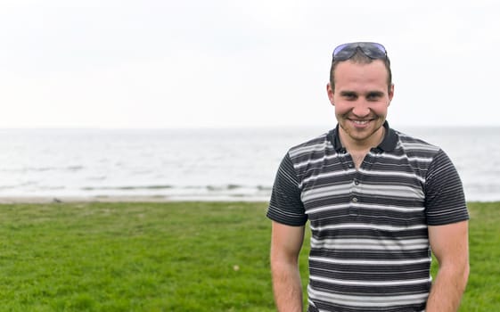 Handsome smiling man near the seaside.