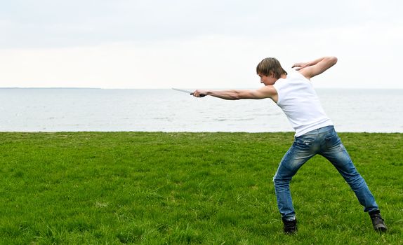 Man with military knife  by the seaside