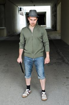 Portrait of a street bandit with knife in hand.