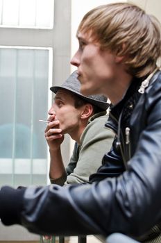 Tough guys. Portrait of two man standing on balcony