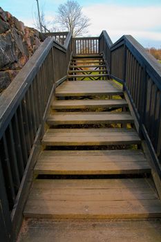 wooden stairs and a rock wall