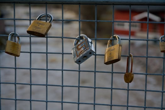 padlocks attached to a fence