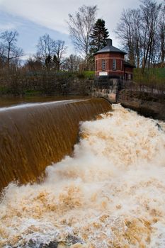 Small waterfall with tiny tower next to