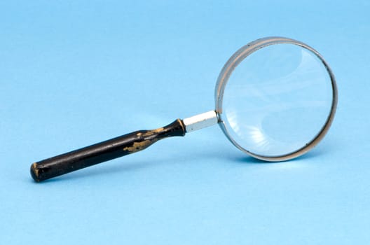 magnifying glass zoom retro tool on blue background.