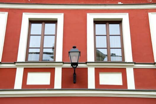 Background of architecture renovated ancient building wall windows and retro lamp hang.