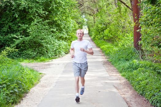 man is jogging in the forest