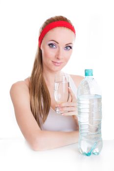 Sporty woman with bottle and glass of water over white