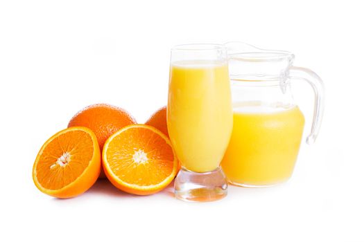 Orange juice in jug and glass over white