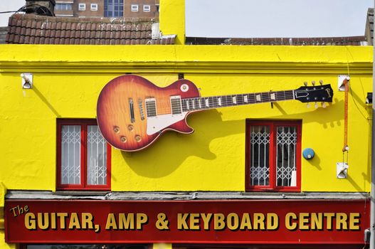Fake Gibson Les Paul on the facade of the Guitar, Amp & Keyboard Centre in Brighton, England, UK