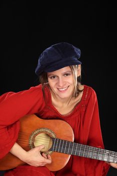 Young beautiful Caucasian woman playing the guitar (Selective Focus, Focus on the face)