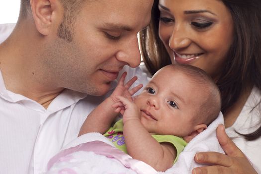 Happy Young Attractive Mixed Race Couple with Newborn Baby.