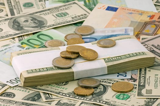 money: euro cents on euro and dollars banknotes