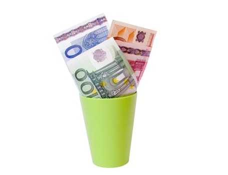 euro banknotes in a cup