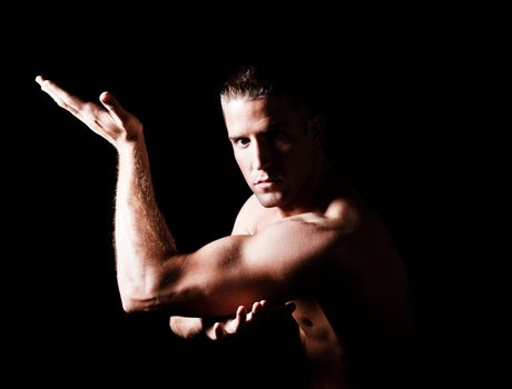 Muscular man isolated on black background