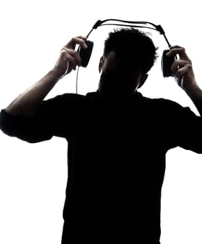 Male in silhouette putting headphones isolated on white background