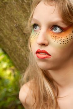 Happy teenager in a forest in the autumn