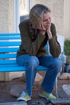 Woman sitting on bench depressed and frustrated