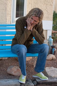 Woman sitting on bench depressed and frustrated