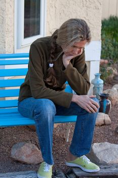 Woman sitting on bench depressed and frustrated