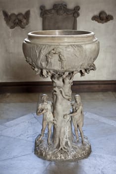 The white marble font in the Church of St. James's Piccadilly created by craftsman Grinling Gibbons (1648-1721).  It depicts Adam and Eve.