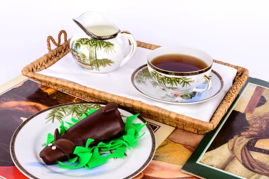 Chocolate cake with tea and milk.