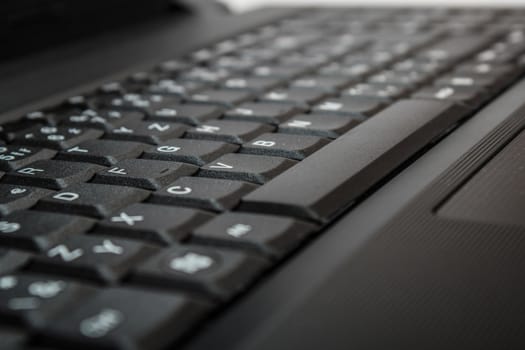 close up of toned laptop keyboard as a background