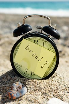 a closeup of an old clock on a beach