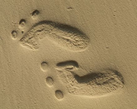 Two small footprints on sand close up