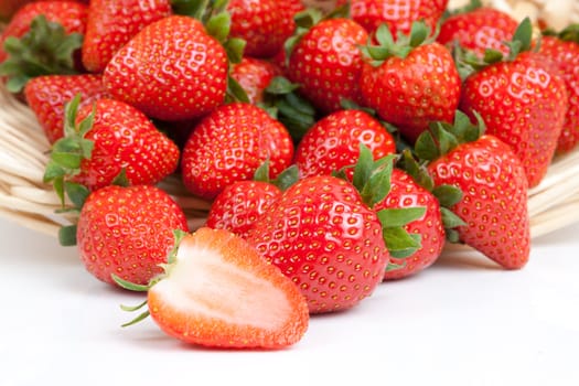 many strawberry falling out from a basket