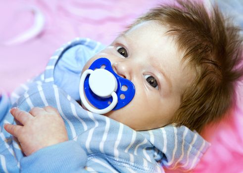 Closeup face of a beautiful newborn baby with brown hair