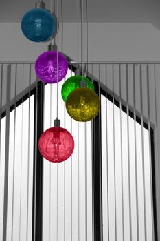 hanging ball lights from a building roof in multi shades