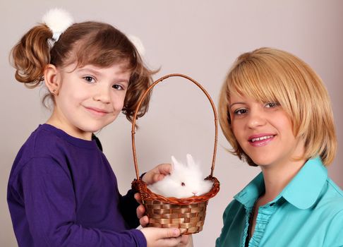 mother and daughter with cute dwarf rabbit