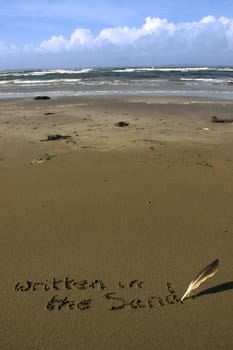 written in the sand inscribed on a sandy beach with a feather quill