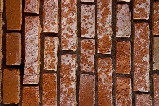 Old red brick wall fragment. Architectural background.