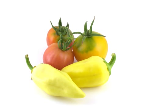 Tomatoes and peppers on white background