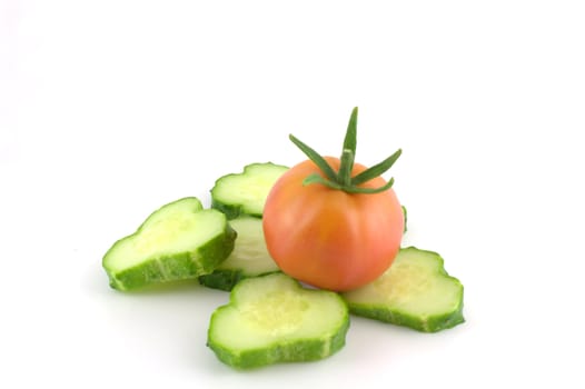Cutted cucumber and tomato over white