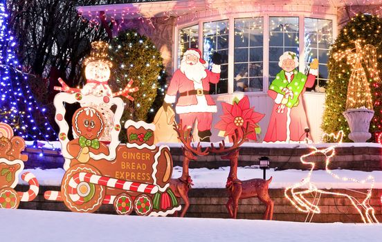 A home is decorated for the Holiday Season with many lights and characters.