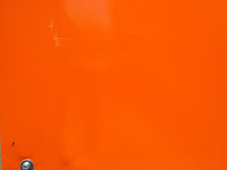orange material with a screw as a background