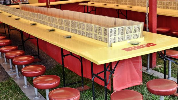 Bingo tables and stools at the state fair in summer.