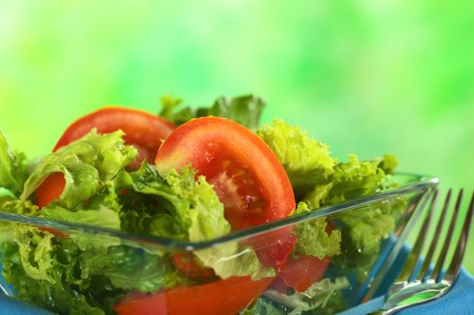 Fresh salad of lettuce and tomato (Selective Focus, Focus on the tomato slice in the middle of the photo) 