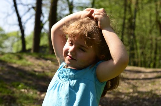 The picture shows her posing what is happy and dreamy in play in the park.