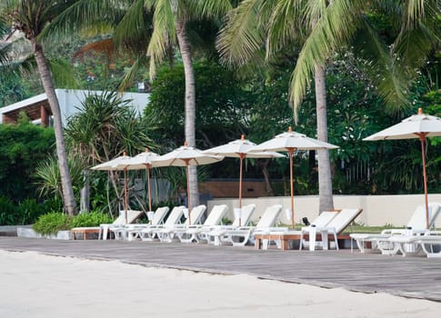 Beach chair and umbrella on tropical sand beach