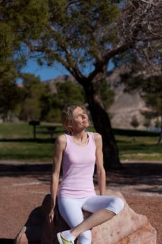 mature women sitting on rock in park