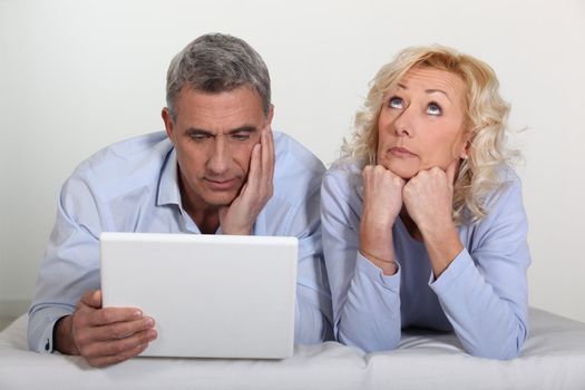 Man and wife bored with computer