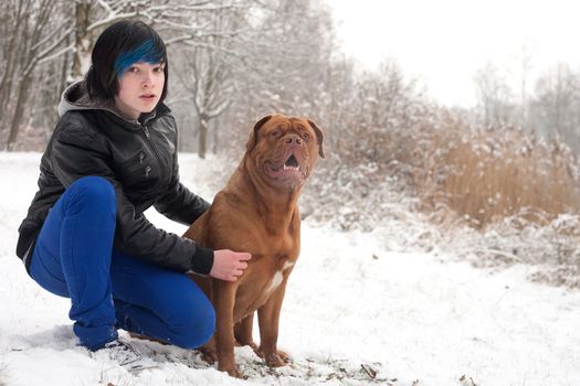 Funky boy is having fun with his dog in the snow