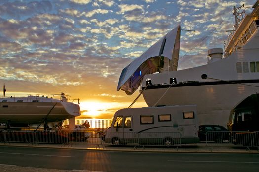 Vehicles waiting on ferry boat docks at sunset, Zadar, Croatia