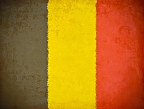 old grunge paper with Belgium flag background