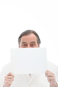 Businessman looking over the top of a sheet of white paper with space for your message or text